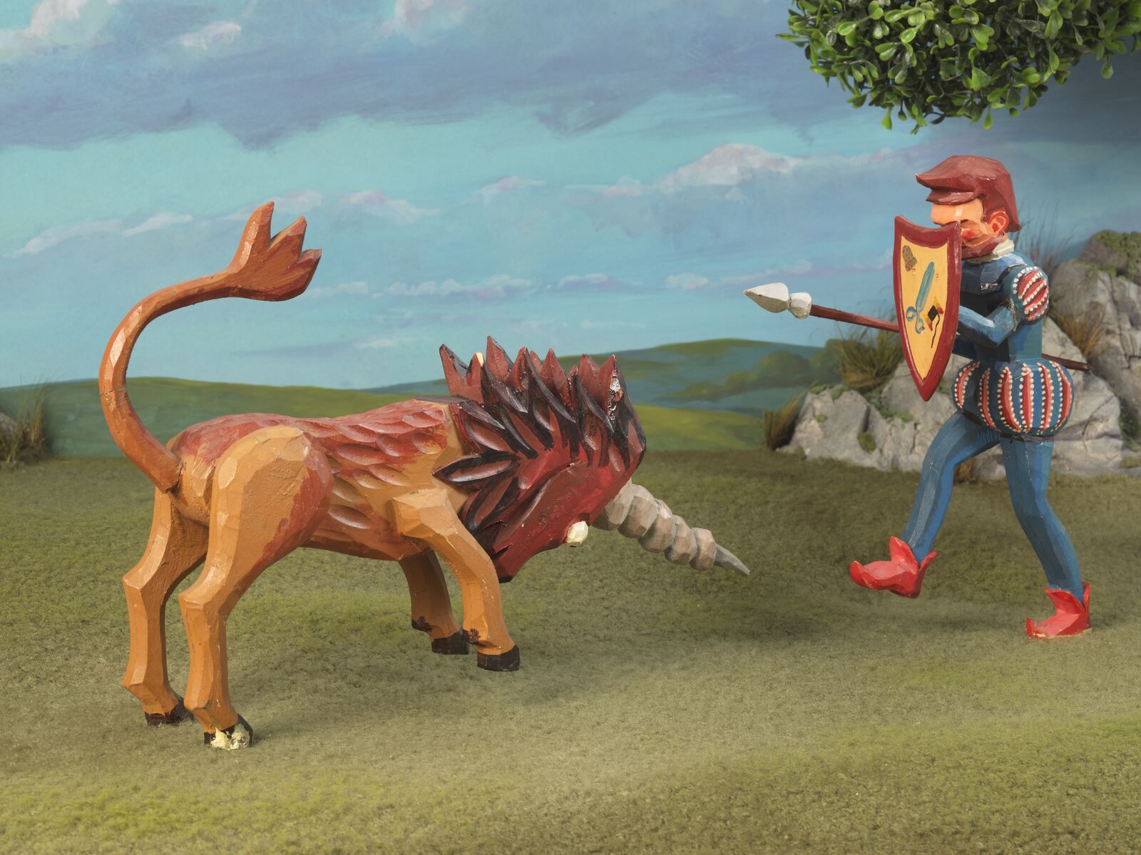 A modern fairytale scene: the toy figure of the unicorn faces off against the gallant tailor.